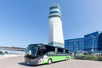 CAT by Bus in front of the tower of Vienna Airport