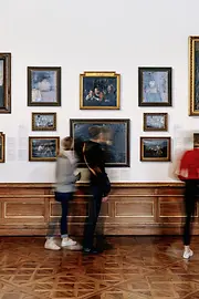 People look at paintings in the Upper Belvedere