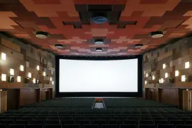 Cinema hall with open curtain, wide screen visible