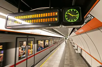 Information panel in the Vienna subway with clock