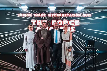 Four persons with Star Wars backdrop