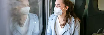Woman wearing an FFP2 mask on a train