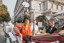 Couple on carriage ride with wine and dessert