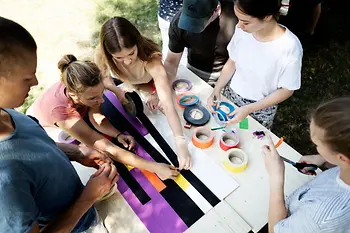A group makes a picture from tape