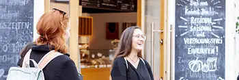 Two women in front of a restaurant