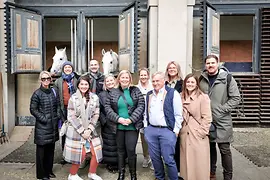 Group photo in front of horse stable