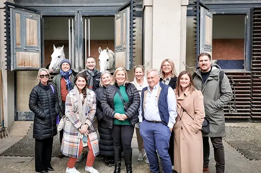 Group photo in front of horse stable
