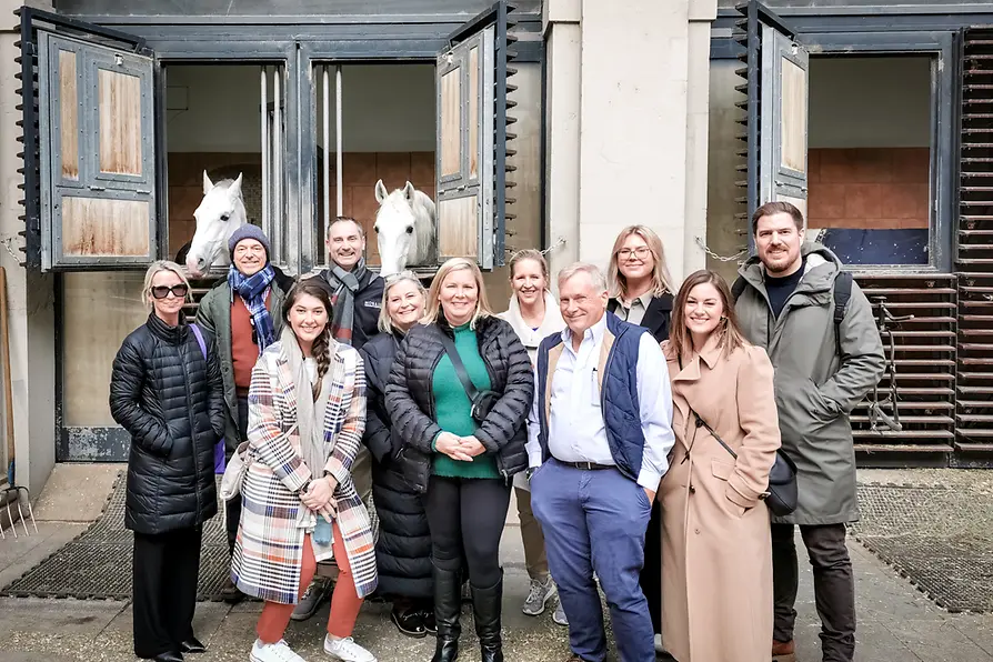 Group photo in front of horse stable
