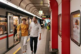 A young couple in a Vienna subway station