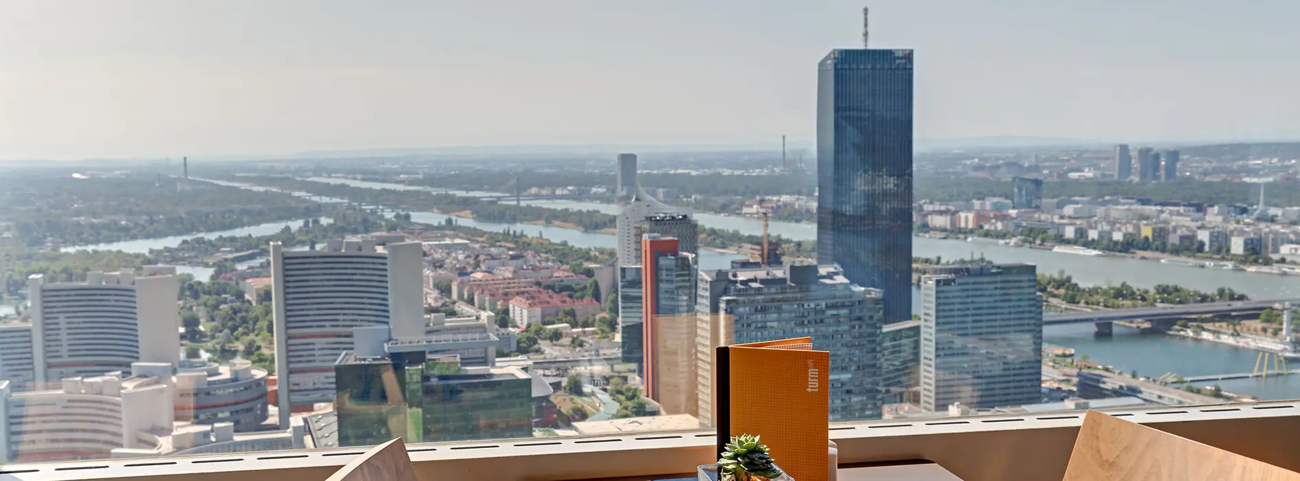 Coffee house table at the glass wall with Vienna panorama in the background