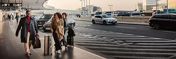 People in front of the airport building