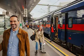 People at the station getting off the train