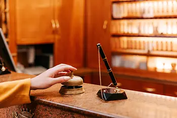 Hotel reception desk with pen and bell