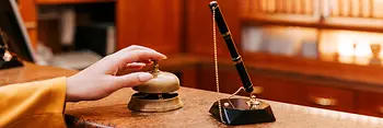 Hotel reception desk with pen and bell